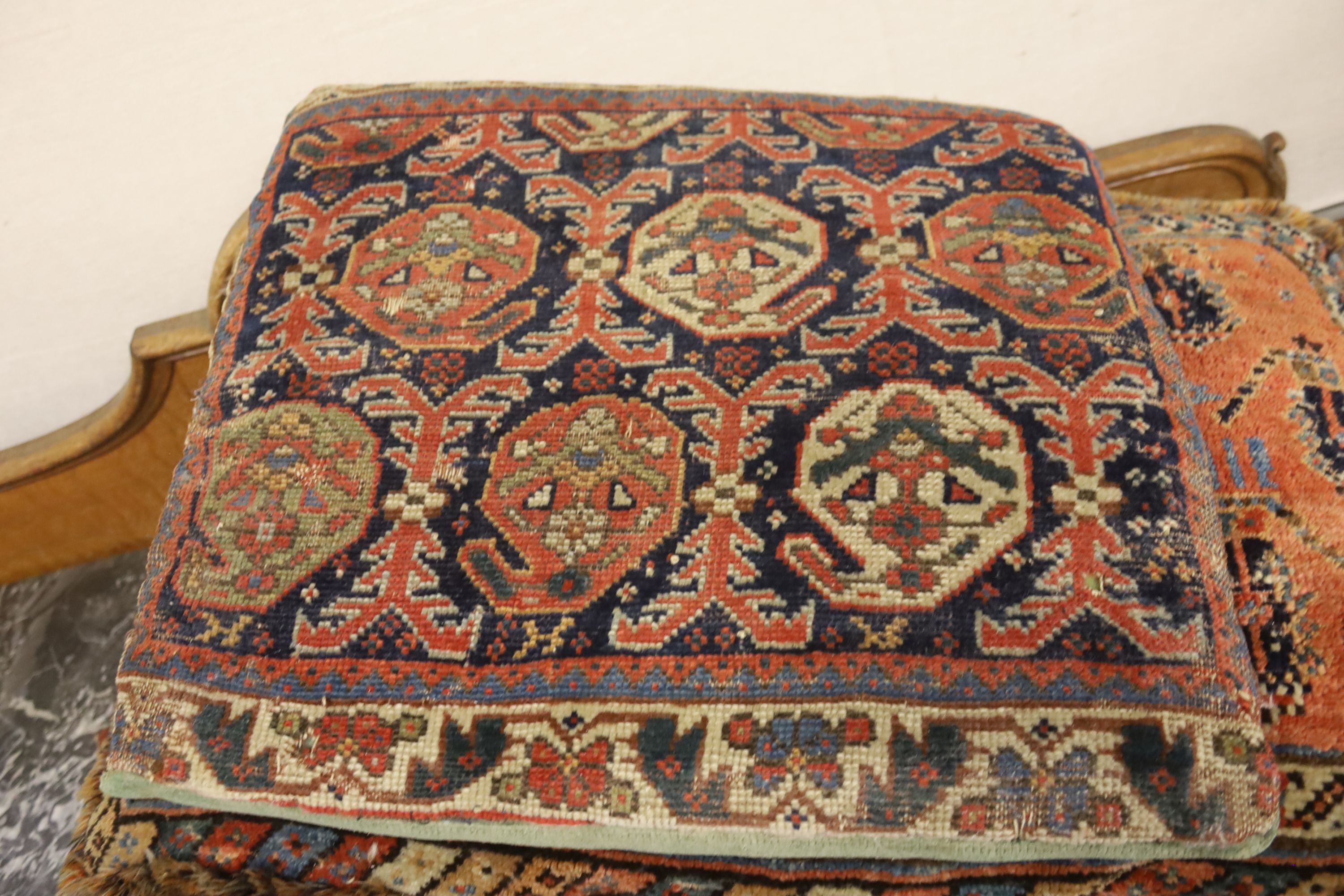 Three Bokhara rugs, four kilim-faced cushions and a small saddlebag, largest 74 x 50cm